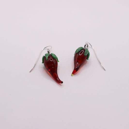 Red chili pepper-shaped earrings on a white background